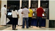 People removing cash from ATMs in Qatar (Reuters)