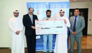 The winners of Doha Bank’s Al Dana savings scheme posing with the QR1m mega prize cheque with senior officials of the Bank. 