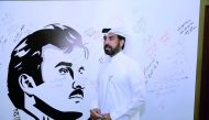 Rashid bin Ali Al Mansoori, CEO of QSE, seen against the backdrop of ‘Tamim Al Majd’ mural, yesterday.