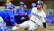 San Diego Padres second baseman Carlos Asuaje (right) is tagged out at home by New York Mets catcher Travis d’Arnaud during the first inning of their MLB game at Petco Park in San Diego on Tuesday.