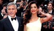 George Clooney and his wife Amal pose on the red carpet as they arrive for the screening of the film 
