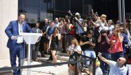 A member of Real Madrid's Portuguese forward Cristiano Ronaldo communication team speaks to the media after Ronaldo appeared before a court in Pozuelo de Alarcon, a wealthy suburb of Madrid, on July 31, 2017 to answer on four counts of tax evasion of 14.7