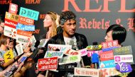 Brazilian football star Neymar Jr. looks on as he speaks to media at a fashion event in Shanghai yesterday. Neymar hit the red carpet in Shanghai yesterday as speculation mounted that the Brazil star could be set to quit Barcelona for Paris Saint-Germain 