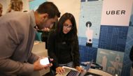 A Uber recruiter talking to a job seeker  at TechFair LA a technology job fair in Los Angeles (REUTERS / Lucy Nicholson) 