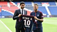 Brazilian superstar Neymar (R) poses with his jersey next to Paris Saint Germain's (PSG) Qatari president Nasser Al-Khelaifi during his official presentation at the Parc des Princes stadium on August 4, 2017. (AFP / PHILIPPE LOPEZ)