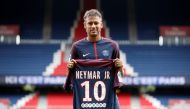 New Paris Saint-Germain signing Neymar Jr poses with the club shirt. (REUTERS/Christian Hartmann)