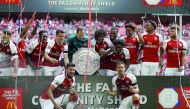 Arsenal players hold the Shield as they celebrate victory after the English FA Community Shield match against Chelsea at Wembley Stadium in London, yesterday.  Arsenal won 4-1 on penalties after the game ended 1-1.