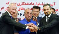 FROM LEFT: Thierry Bollore, Deputy Director of Competitiveness at Renault, Mansour Moazami, Chairman of the Board of Directors of IDRO Group, and Kourosh Morshed Solouk, Deputy Director of the Iranian Automobile Importers Association, shaking hands at the