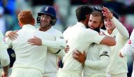 England’s Moeen Ali (second right) celebrates along with his team-mates after taking wicket of South Africa’s Duanne Olivier to seal victory in the fourth and final Test at Old Trafford in Manchester, yesterday. England won the match by 177 runs to secure