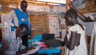 Sandy makes sure she is registered at the child friendly space, where she can play and receive psychosocial support in Juba, South Sudan on July 28, 2017. Thomson Reuters Foundation/Stefanie Glinski