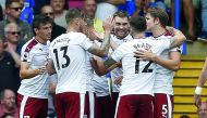 Burnley’s Welsh striker Sam Vokes (centre) celebrates with team-mates after scoring the opening goal of their Premier League game against Chelsea in London yesterday. 