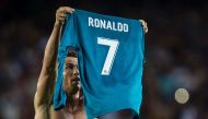Real Madrid's Portuguese forward Cristiano Ronaldo takes off his jersey to celebrate his goal during the first leg of the Spanish Supercup football match between FC Barcelona and Real Madrid CF at the Camp Nou stadium in Barcelona on August 13, 2017. AFP 