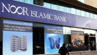 A woman walks past a branch of Noor Islamic Bank in Dubai. (Reuters / File photo)