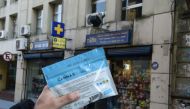 (File Photo) A man holds an envelope of marijuana that he purchased at a pharmacy in Montevideo in this file photo from July 19