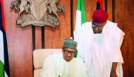 Nigerian President Mohammadu Buhari sitting beside his Chief of Staff Abba Kyari as he writes to the National Assembly, notifying the legislature of his return to office, after a medical vacation from London, in Abuja, yesterday.