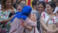 BARCELONA, SPAIN - AUGUST 21: Two women hug as they mourn during a demonstration against terror attacks and solidarity with the victims of the terror attack in Barcelona, Spain on August 21, 2017. ( Albert Llop - Anadolu Agency ).