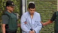 Mohamed Houli Chemlal, suspected of involvement in the terror cell that carried out twin attacks in Spain, is escorded by Spanish Civil Guards from a detention center in Tres Cantos, near Madrid, on August 22, 2017 before being tranferred to the.   AFP / 