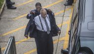 Andrew Wyatt(L) helps Bill Cosby put his suit coat on after Cosby arrived at the Montgomery County Courthouse on August 22, 2017 in Norristown, Pennsylvania.  AFP / Michael Bryant