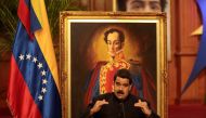 Venezuela's President Nicolas Maduro talks to the media in front of an image of Venezuela's national hero Simon Bolivar, during a news conference at Miraflores Palace in Caracas, Venezuela August 22, 2017. REUTERS/Marco Bello.