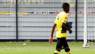 (FILES) This file photo taken on August 9, 2017 shows Dortmund's French midfielder Ousmane Dembele walking accross the pitch during a press event of German first division Bundesliga football club Borussia Dortmund in Dortmund, western Germany.  AFP / PATR
