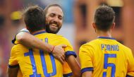 Juventus' Argentinian forward Paulo Dybala (L) celebrates with compatriot forward Gonzalo Higuain (C) after scoring during the Italian Serie A football match Genoa v Juventus at The Luigi Ferraris Stadium in Genoa on August 26, 2017. / AFP / Marco BERTORE