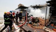 A firefighter hoses down at the site of a car bomb attack in Jamila market in Sadr City district of Baghdad, Iraq August 28, 2017. REUTERS/Wissm al-Okili
