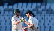 Australian cricket captain Steven Smith (L) and David Warner (R)congratulate each other as they walk off the field during the third day of the first Test cricket match between Bangladesh and Australia at the Sher-e-Bangla National Cricket Stadium in Dhaka