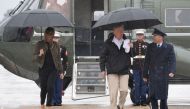 US President Donald Trump and First Lady Melania Trump walk to board Air Force One at Andrews Air Force Base, Maryland, on August 29, 2017 en route to Texas to view the damage caused by Hurricane Harvey. / AFP / JIM WATSON
