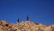 A picture taken on an army-organized press tour shows Lebanese army soldiers with the 6th Brigade watching the Syrian border from a hill recently taken from the Islamic State (IS) group in Jurud Ras Baalbeck on the Syrian-Lebanese border on August 28, 201