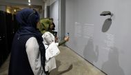 Visitors viewing the belongings of Syrians who have been detained or forcibly disappeared in regime jails on display at an exhibition by Amnesty International in the Lebanese capital Beirut on August 30, 2017.  AFP / Anwar Amro