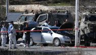FILE PHOT: Israeli forces gather around the body of a Palestinian shot dead at a checkpoint near the Beit El settlement close to West Bank city of Ramallah on January 31, 2016 (AFP / Ahmad Gharabli)