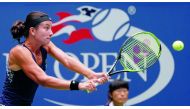 Anastasija Sevastova of Latvia returns the ball to Maria Sharapova of Russia during their fourth round match of the US Open on Sunday. The Latvian 16th seed Sevastova rallied to eliminate the five-time Grand Slam champion 5-7, 6-4, 6-2 and advanced to the
