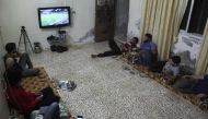 Syrian football fans watch the Portugal vs Hungary World Cup qualifier football match at a friend's house in Binnish on the outskirts of Idlib on September 3, 2017.  AFP / OMAR HAJ KADOUR
