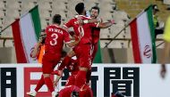Syria's players celebrate after scoring a goal against Iran during the FIFA World Cup 2018 qualification football match between Iran and Syria at the Azadi Stadium in Tehran on September 5, 2017. / AFP / ATTA KENARE
