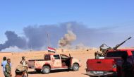 Smoke billows as Syrian government forces advance in Al-Shula on the southwestern outskirts of Deir Ezzor on September 8, 2017, during the ongoing battle against Islamic State (IS) group jihadists.  AFP / George OURFALIAN
