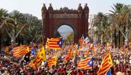 (FILES) This file photo taken on September 11, 2016 shows people waving 'Esteladas' (pro-independence Catalan flags) as they gather during a pro-independence demonstration, in Barcelona during the National Day of Catalonia 'Diada'.  AFP / PAU BARRENA
