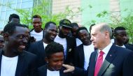 President of Turkey, Recep Tayyip Erdogan (right), talks to players of Istanbul Fatih Municipality African Friendship Sports Team after attending the Mayors Consultation and Evaluation Meeting at ATO Congresium in Ankara, yesterday.