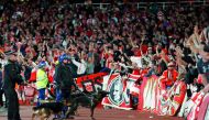 Police inside the stadium keep an eye on Cologne supporters in the stands as the kick off was delayed due to crowd safety issues ahead of the UEFA Europa League Group H football match between Arsenal and FC Cologne at the Emirates Stadium in London on Thu