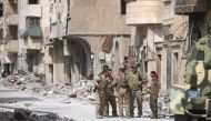 Fighters from Syrian Democratic Forces (SDF) stand together along a damaged street in Raqqa, Syria September 16, 2017. REUTERS/ Rodi Said