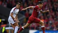 Liverpool's Brazilian midfielder Philippe Coutinho (R) runs away from Burnley's English defender Matthew Lowton during the English Premier League football match between Liverpool and Burnley at Anfield in Liverpool, north west England on September 16, 201