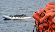 FILE PHOTO: Migrants on a rubber boat waiting to be evacuated during a rescue operation by the crew of the Topaz Responder on November 5, 2016 off the coast of Libya. (AFP / Andreas Solaro) 