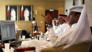 Traders monitor screens displaying stock information at Qatar Stock Exchange in Doha in this file photo (Reuters / Naseem Zeitoon) 