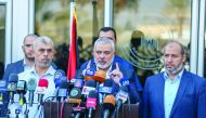 Ismail Haniyah (centre), Head of the Political Bureau of Hamas, speaking to media at Rafah border crossing following his visit to Egypt, yesterday.