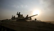 Members of the Iraqi forces flash the victory gesture as they ride in an infrantry fighting vehicle (IFV) during the advance towards the city of al-Sharqat on September 21, 2017,  AFP / AHMAD AL-RUBAYE