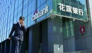 A man walks past a branch of Citibank in Beijing.