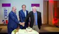 QBBF officials cutting a cake to celebrate the 25th anniversary of the forum.