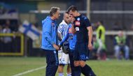 Napoli's Arkadiusz Milik walks off the pitch with medical staff after going down injured REUTERS/Alberto Lingria
