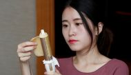 Ms Yeah demonstrates to make an egg roll with a hair curler in Hong Kong, China September 14, 2017. Picture taken September 14, 2017. REUTERS/Bobby Yip
