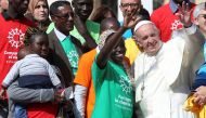 Pope Francis poses with a group of migrants during the Wednesday general audience in Saint Peter's Square at the Vatican, September 27, 2017. Reuters/Alessandro Bianchi
