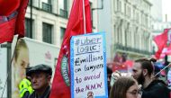 People take part in a protest against Uber and in favour of labour rights in central London, Britain, September 27, 2017. REUTERS/Mary Turner